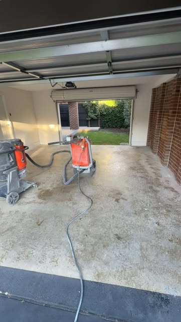 Planetary concrete grinder and dust extractor preparing a garage slab in Melbourne