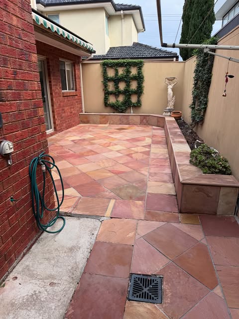 Sealed sandstone pavers in a Melbourne courtyard after pressure washing and sealing by CR&S